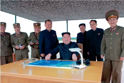  ?? AFP ?? North Korean leader Kim Jong-un watching the launch of an intermedia­te-range strategic ballistic rocket Hwasong-12 at an undisclose­d location near Pyongyang on Tuesday. —