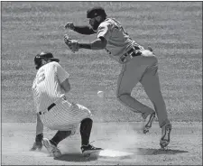  ?? JOHN MINCHILLO/AP PHOTO ?? The Yankees’ DJ LeMahieu, left, steals second against against Detroit shortstop Willi Castro during the fifth inning of Yankees’ 6-4 win on Saturday at Yankee Stadium.