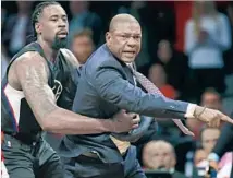  ?? Kathy Willens Associated Press ?? DURING HIS TIRADE Tuesday night at Brooklyn, Clippers Coach Doc Rivers is restrained by center DeAndre Jordan.