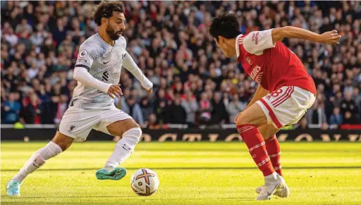  ?? ?? Liverpool’s forward, Mo Salah tries to go pass Arsenal wing back. Takehiro Tomiyasu