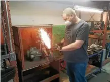  ?? DONNA ROVINS — DIGITAL FIRST MEDIA ?? Two Pottstown small businesses have formed a business alliance that includes sharing work space on West High Street. Shown here, Barry Gassen Jr. of Pro Tool Industries grinds a blade for the company’s Woodman’s Pal machete. Palladino Metal Fabricatio­n...