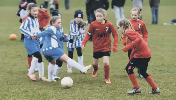  ??  ?? Russell Foster action from Houghall College, Peterlee, with Consett AFC Juniors Jets Girls U9s (red) facing Hartlepool Youth Whites (blue/white)