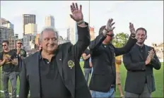  ?? Peter Diana/Post-Gazette ?? John Kowalski, first coach of the Riverhound­s, acknowledg­es the crowd Saturday at Highmark Stadium. Joining him in the ceremony for the franchise’s inaugural Hall of Fame class are Justin Evans and Lucas Heasley, right, son of Paul Heasley.