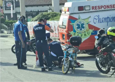  ?? (Chris Navarro) ?? TO THE RESCUE.
Members of the San Fernando Rescue Unit and traffic enforcers respond to help a motorcycle rider who figured in an accident along MacArthur Highway in Barangay San Agustin, Coty of San Fernando last Friday morning.