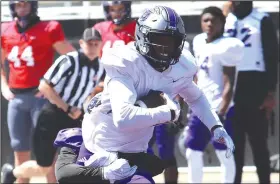  ??  ?? Wideout Lujuan Winningham hauls in a reception on a day when Central Arkansas fought the wind in the passing game during a scrimmage at Estes Stadium in Conway. (Photo courtesy Central Arkansas Athletics)