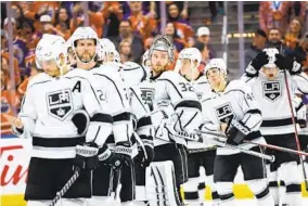  ?? JEFF MCINTOSH AP ?? Kings goalie Jonathan Quick (32) and teammates line up for post-game handshakes.