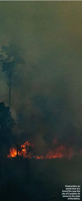  ??  ?? Destructio­n: an aerial view of a forest fire near the city of Candeias do Jamari in the state
of Rondônia.