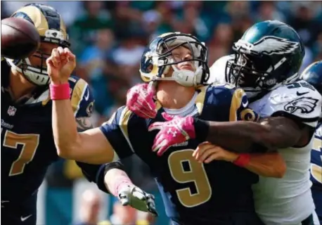  ?? THE ASSOCIATED PRESS FILE ?? Then-Eagles defensive end Trent Cole, right, knocks the ball loose from St. Louis Rams’ quarterbac­k Austin Davis during a game between the teams on Oct. 5, 2014, Cole’s last season as an Eagle. Cole will retire as an Eagle in a ceremony before the...