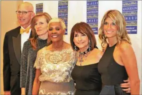  ??  ?? Headliner and award recipient Dionne Warwick, center, is joined by several members of her entourage