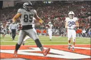  ?? Jay LaPrete / Associated Press ?? Ohio State tight end Marcus Baugh scores a touchdown against Penn State during the second half Saturday in Columbus, Ohio. Ohio State beat Penn State 39-38.