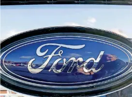  ?? [AP PHOTO] ?? The blue Ford oval badge is shown in the grill of a pickup truck on the sales lot at Butler County Ford in Butler, Pa.