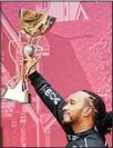  ?? ?? Mercedes driver Lewis Hamilton of Britain holds a trophy after wining the Russian Formula One Grand Prix at the Sochi Autodrom circuit, in Sochi, Russia, on Sept 26. (AP)