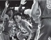  ?? JOSHUA L. JONES Athens Banner-Herald ?? Georgia’s Nicolas Claxton is swarmed by Florida defenders, from left, Dontay Bassett, Andrew Nembhard and KeVaughn Allen on Saturday as the Gators went on a 19-4 run late in the second half to beat the SEC rival Bulldogs.