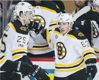  ?? JEFF MCINTOSH / THE CANADIAN PRESS ?? Boston Bruins forward Brad Marchand, right, is among the legion of NHL players voicing a desire to be a part of the 2018 Winter Olympic Games in PyeongChan­g, South Korea. Maple Leafs head coach Mike Babcock is on board, too.