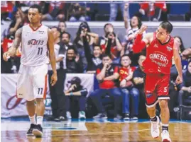  ?? (Rio Deluvio) ?? GINEBRA peppery guard LA Tenorio (right) punches the air in delight after a basket against Meralco’s Chris Newsome.