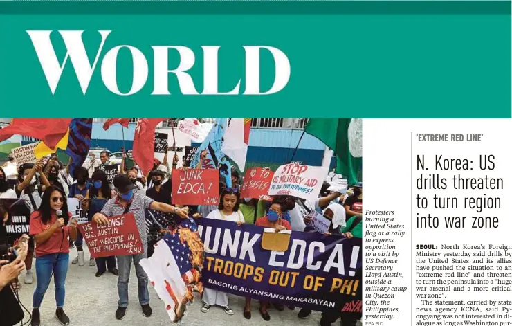  ?? EPA PIC ?? Protesters burning a United States flag at a rally to express opposition to a visit by US Defence Secretary Lloyd Austin, outside a military camp in Quezon City, the Philippine­s, yesterday.