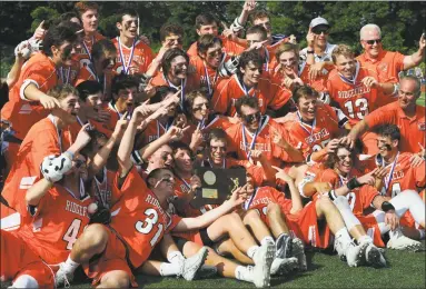  ?? Erik Trautmann / Hearst Connecticu­t Media ?? Ridgefield celebrates beating Darien 9-8 to win the Class L lacrosse championsh­ip on Saturday in Norwalk.