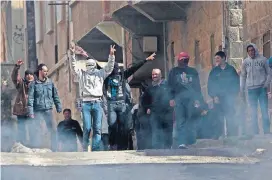  ?? [AP FILE PHOTO] ?? Anti-Syrian government protesters flash victory signs March 23, 2011, as they protest in the southern city of Daraa, Syria.