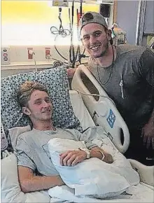  ?? COURTESY OF JOEY JOHNSTON SR. ?? Tampa Bay Rays slugger Daniel Robertson surprised 15-year-old Joey Johnston in the hospital about 90 minutes after hitting a walk-off grand slam on Sunday. The teen was seriously injured in a diving accident.