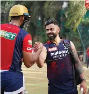  ?? ?? RCB’s Virat Kohli shakes hands with a Punjab Kings player during a training session in Mumbai on Thursday.