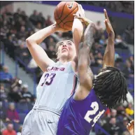 ?? Stephen Dunn / Associated Press ?? Katie Lou Samuelson, left, had 26 points, 16 rebounds, six assists and two steals in Saturday’s 99-61 victory over Seton Hall.