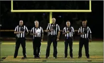  ?? ANDA CHU — BAY AREA NEWS GROUP, FILE ?? Referees stand during the playing of the national anthem before a 2019 game between Moreau Catholic and James Logan in Hayward.