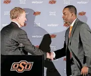  ?? [PHOTO BY STEVE GOOCH, THE OKLAHOMAN] ?? ABOVE: Lamont Evans was an assistant coach at South Carolina before joining the Cowboys’ staff. [AP PHOTO]
LEFT: OSU athletic director Mike Holder, left, introduces Mike Boynton as the Cowboy basketball coach last March.