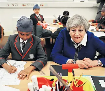  ??  ?? Theresa May meets pupils at Nishkam Primary School in Birmingham where she revealed she was a fan of the Harry Potter books