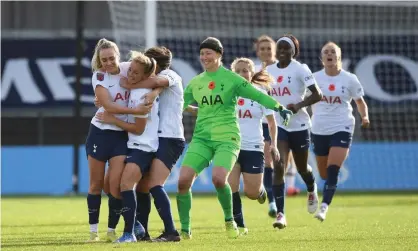  ?? ?? Tottenham’s Ria Percival is mobbed by her teammates after her late equaliser against Manchester­United. Photograph: Harriet Lander/ Getty Images