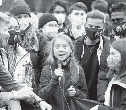  ?? ANDREW MILLIGAN/AP ?? Swedish climate activist Greta Thunberg, center, speaks alongside fellow climate activists during a demonstrat­ion on the first day of the COP26 summit, in Glasgow, Scotland, on Nov. 1.