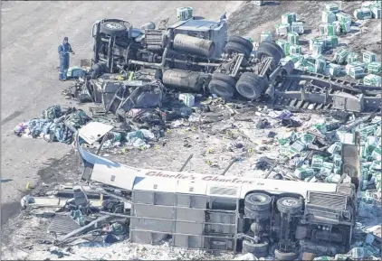  ?? CP PHOTO ?? The wreckage of a fatal bus crash involving the Humboldt Broncos hockey team is seen outside of Tisdale, Sask. on Saturday, April, 7.