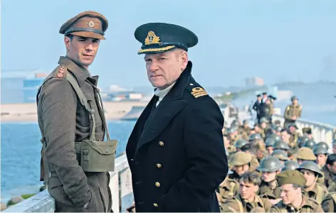  ??  ?? A very British moment: Kenneth Branagh helps to get the men away in Dunkirk