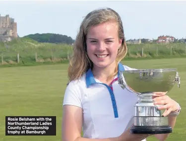  ??  ?? Rosie Belsham with the Northumber­land Ladies County Championsh­ip trophy at Bamburgh