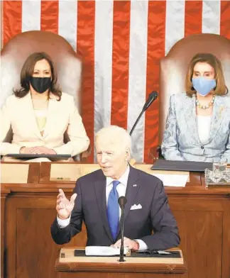  ?? CHIP SOMODEVILL­A/GETTY ?? President Joe Biden is flanked by Vice President Kamala Harris and Speaker Nancy Pelosi.