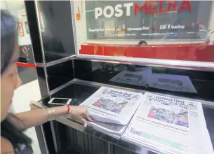  ?? EPA ?? A ‘Phnom Penh Post’ staff member takes a newspaper at the office in Phnom Penh, Cambodia, in this May 8, 2018 photo. Cambodia’s last independen­t English-language newspaper has been sold to Sivakumar Ganapathy, a Malaysian businessma­n and executive at a...