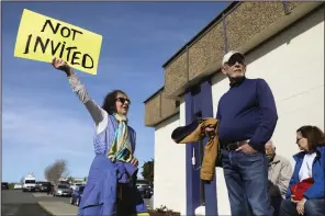  ?? (AP/San Francisco Chronicle/Jessica Christian) ?? Solano County and Rio Vista residents Kathleen Threlfall (left) and Bill Mortimore protest outside a press conference unveiling California Forever’s plans after being shut out of the event held in Rio Vista, Calif., in January.