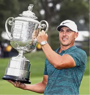  ??  ?? It was worth it: Brooks Koepka posing with the Wanamaker Trophy after winning the PGA Championsh­ip on Sunday. — AP