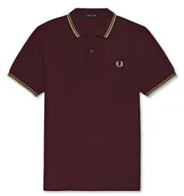  ??  ?? FRED PERRY
Cotton piqué polo shirt with twin tipping collar and cuffs / € 90