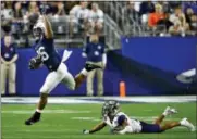  ?? ROSS D. FRANKLIN — THE ASSOCIATED PRESS ?? Penn State running back Saquon Barkley (26) leaps over Washington defensive back Myles Bryant (5) during the second half of the Fiesta Bowl Saturday in Glendale, Ariz.