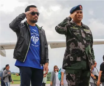  ??  ?? RESPECT: Manny ‘Pacman’ Pacquiao salutes as he reviews honour guards during an arrival ceremony at General Santos city airport yesterday.