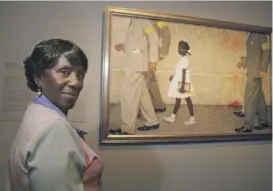  ?? STEVE UECKERT/ HOUSTON CHRONICLE VIA AP ?? Lucille Bridges poses in 2006 next to the original 1964 Norman Rockwell painting “The Problem We All Live With,” showing her daughter Ruby, inside the Museum of Fine Arts in Houston.