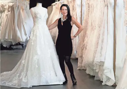  ?? DE SISTI / MILWAUKEE JOURNAL SENTINEL MIKE ?? White Dress Off the Rack owner Christina Alexander Wegner stands in the assortment of bridal gowns available at the store, 196 S. Second St. White Dress Off the Rack is focused on brides with limited time to plan and a smaller budget.