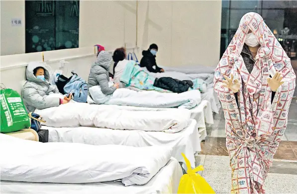  ??  ?? An exhibition centre in Wuhan has been converted into a makeshift hospital to treat people suffering from coronaviru­s