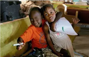  ??  ?? a couple of Haitian kids playing inside the new Haitian Mission church used as a shelter located close to sand banks neighbourh­ood.