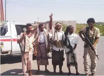  ?? Courtesy: Facebook ?? Yemeni forces flash the victory sign yesterday after taking control of Khokha region on the Red Sea, 122km south of Hodeida city, after fierce clashes with the Iran-backed Al Houthis.