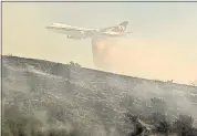  ?? THE ASSOCIATED PRESS ?? A Boeing Evergreen B-747 Supertanke­r drops fire retardant near Palmdale in 2010. A report released Friday says firefighte­r Matthew Burchett was killed on Aug. 13 by a tree uprooted when liquid was dropped from a similar plane.