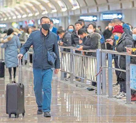  ?? Pictures: AP and Shuttersto­ck. ?? A traveller wearing a face mask at Beijing Airport, above. Below, face masks being worn in Hong Kong.