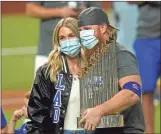  ?? AP - Eric Gay ?? Dodgers third baseman Justin Turner holds the World Series trophy as he poses with his wife, Kourtney, after Tuesday’s clinching win against the Rays.