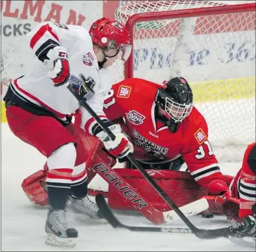  ?? Photos/colleen De Neve/ Calgary Herald ?? Brooks Bandits defenceman Chris Muscoby, left, takes a shot on the net of Whitecourt Wolverines goalie Tanner Kovacs during their AJHL game in Brooks.