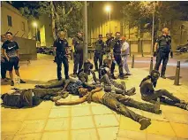  ?? PHOTO: REUTERS ?? African migrants lie exhausted after crossing the border from Morocco to Spain’s North African enclave of Ceuta.